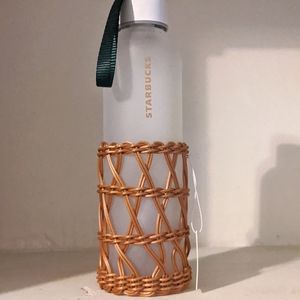 Frosted glass bottle with wicker sleeve